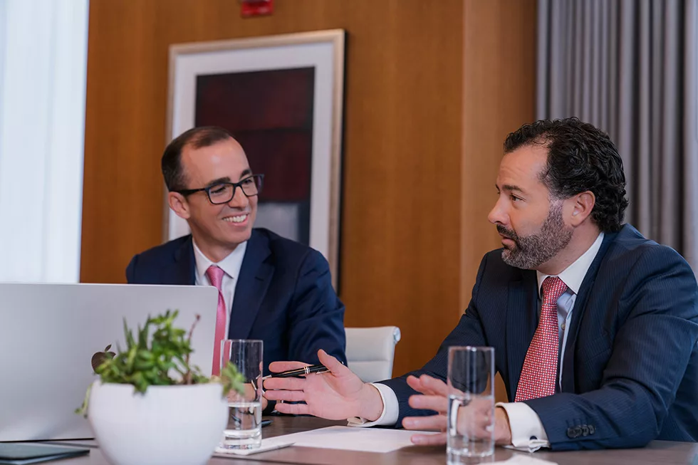 Marcello Zaffaroni and Juan Campuzano of Hillguard Wealth Management having a discussion at their offices in Miami.